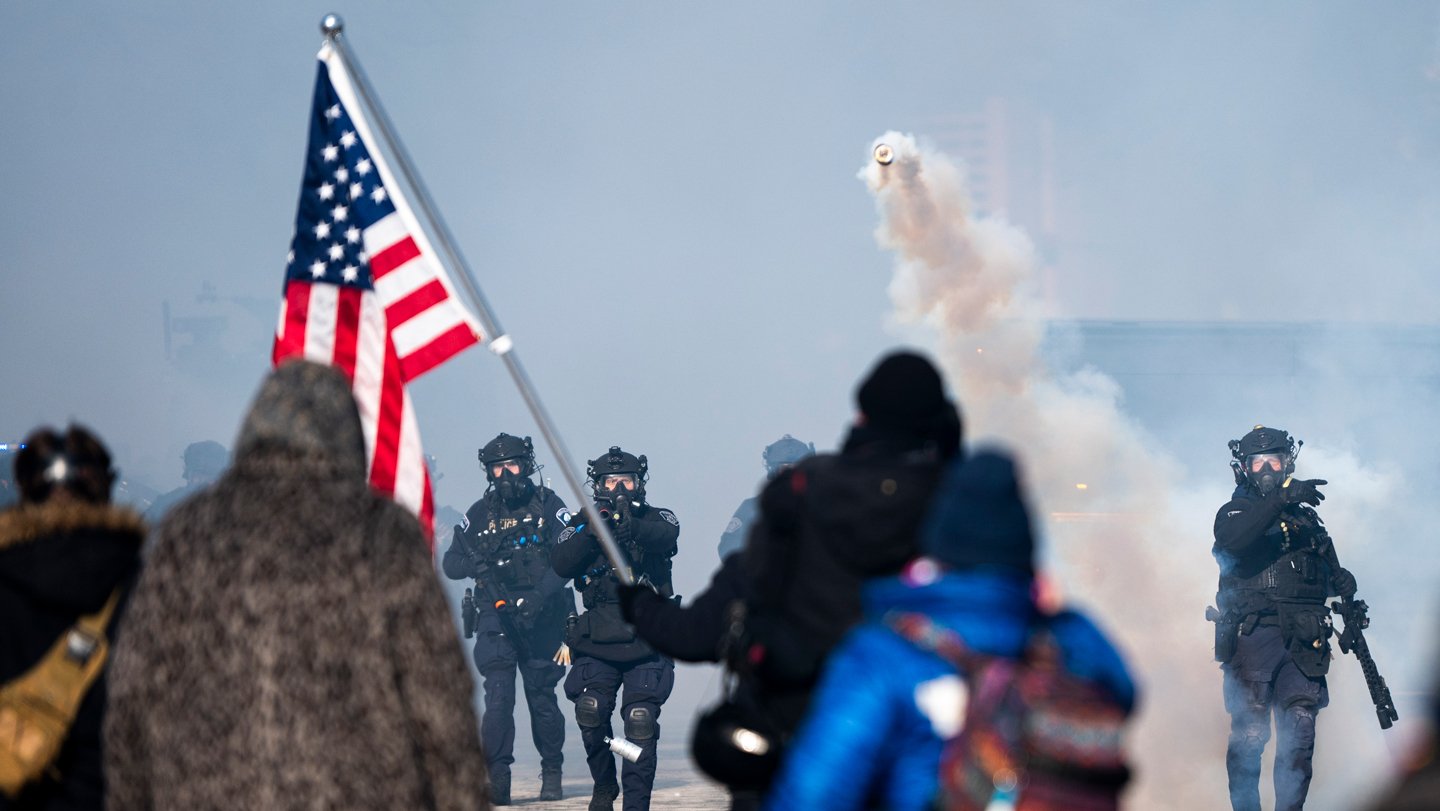 A canister of tear gas flies toward demonstrators in Minneapolis on January 24, where the Departm...
