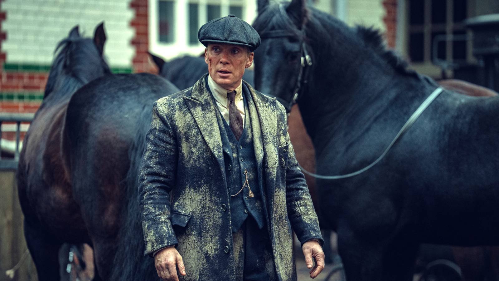 Cillian Murphy as Tommy Shelby in a muddy suit in Peaky Blinders The Immortal Man