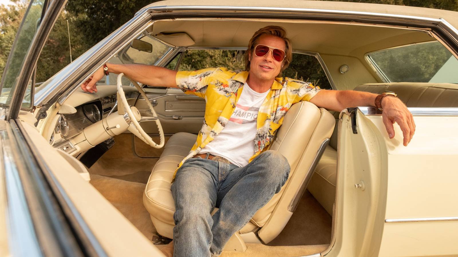 Cliff Booth poses in a car in Once Upon a Time... in Hollywood