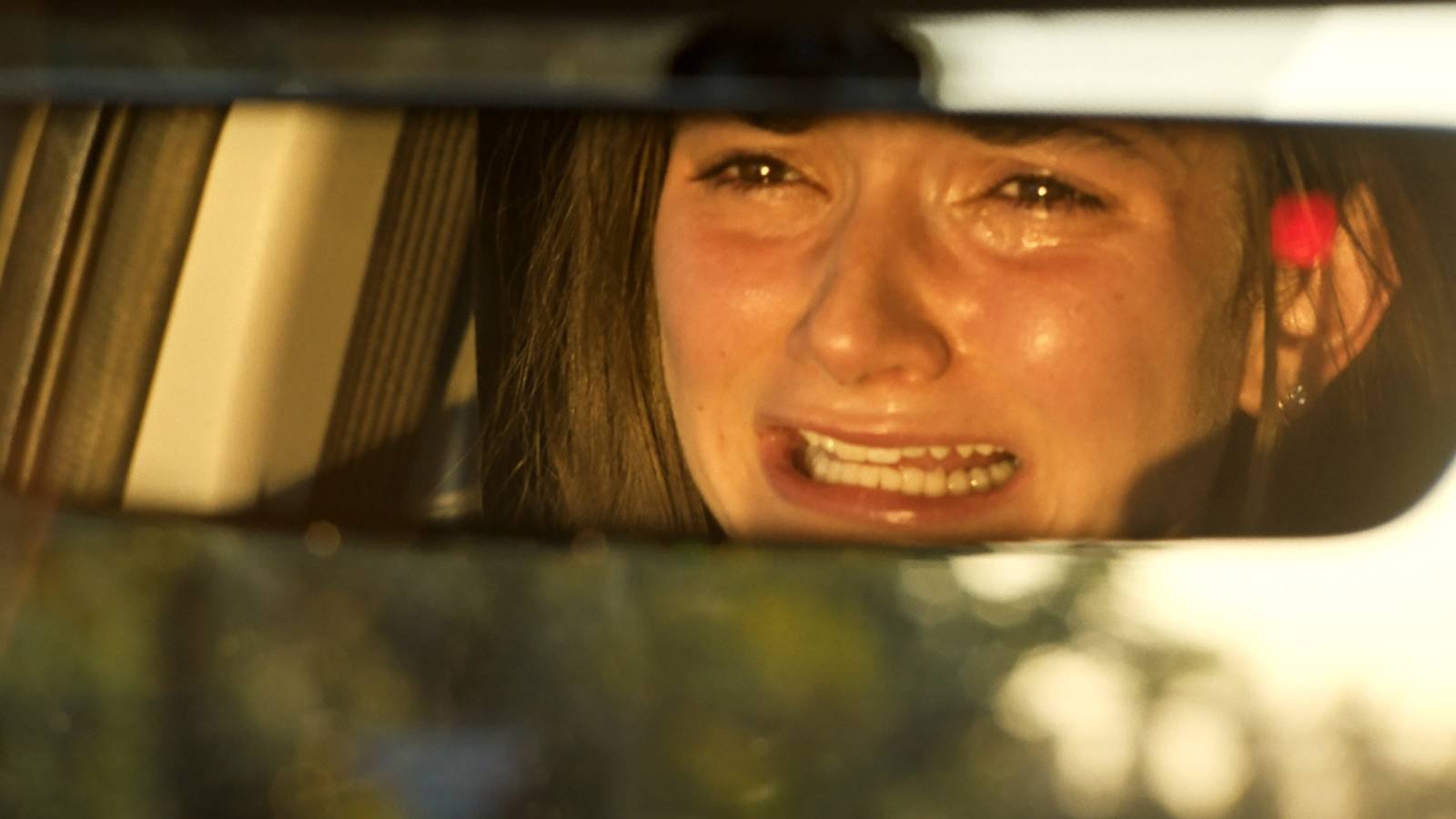 Emily Robinson's Delaney crying in a rearview mirror in Ugly Cry