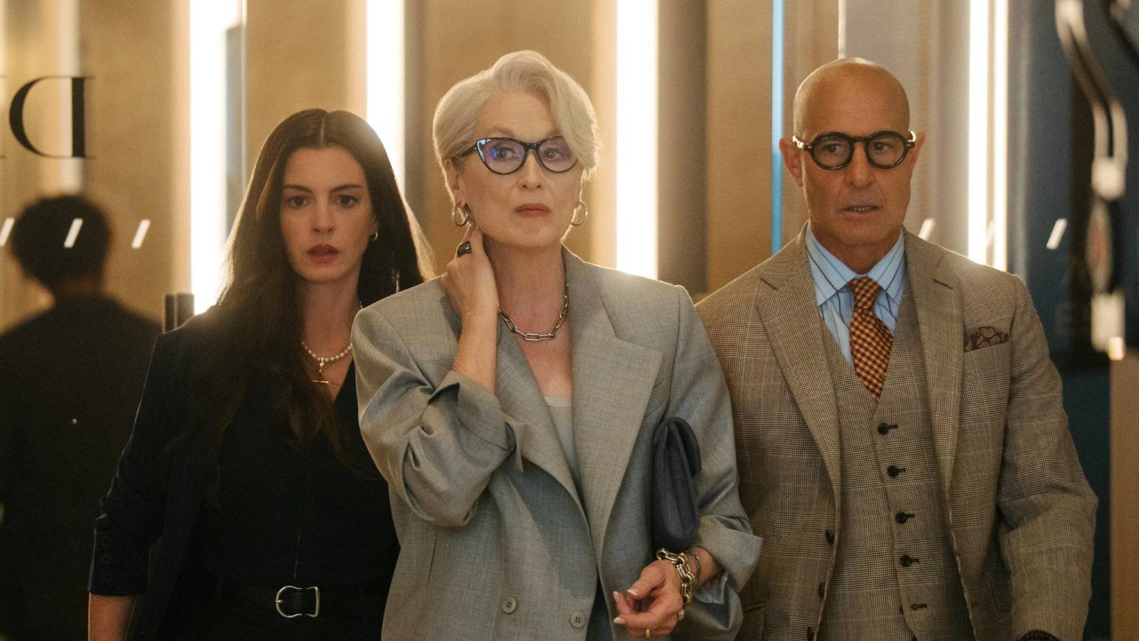 Anne Hathaway as Andrea Sachs, Meryl Streep as Miranda Priestley, and Stanley Tucci as Nigel in T...