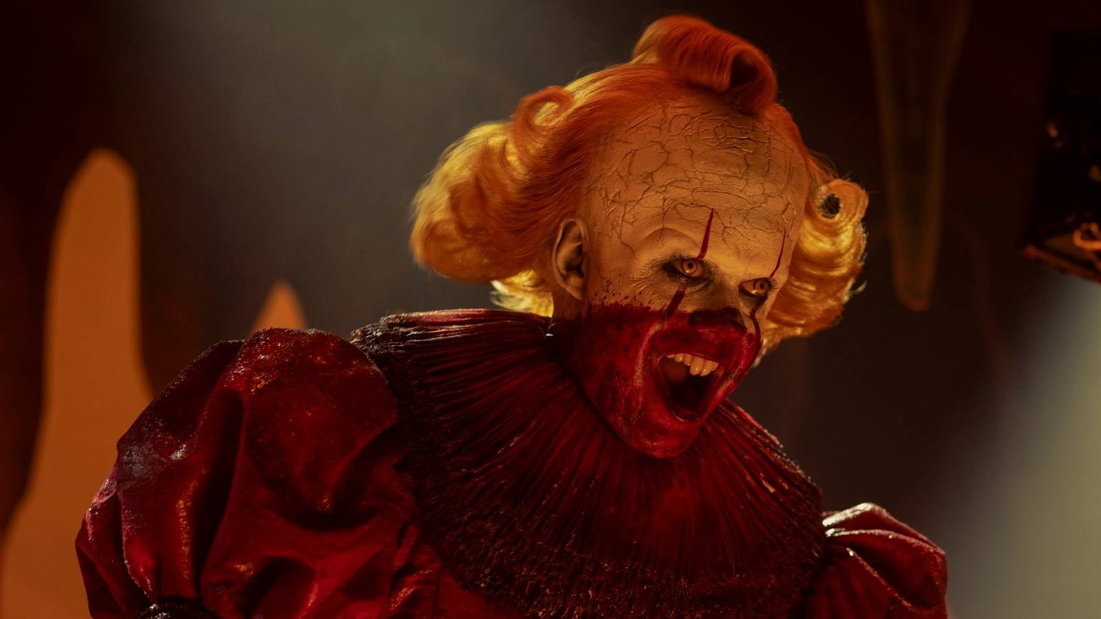 Pennywise covered in blood laughing in IT Welcome to Derry
