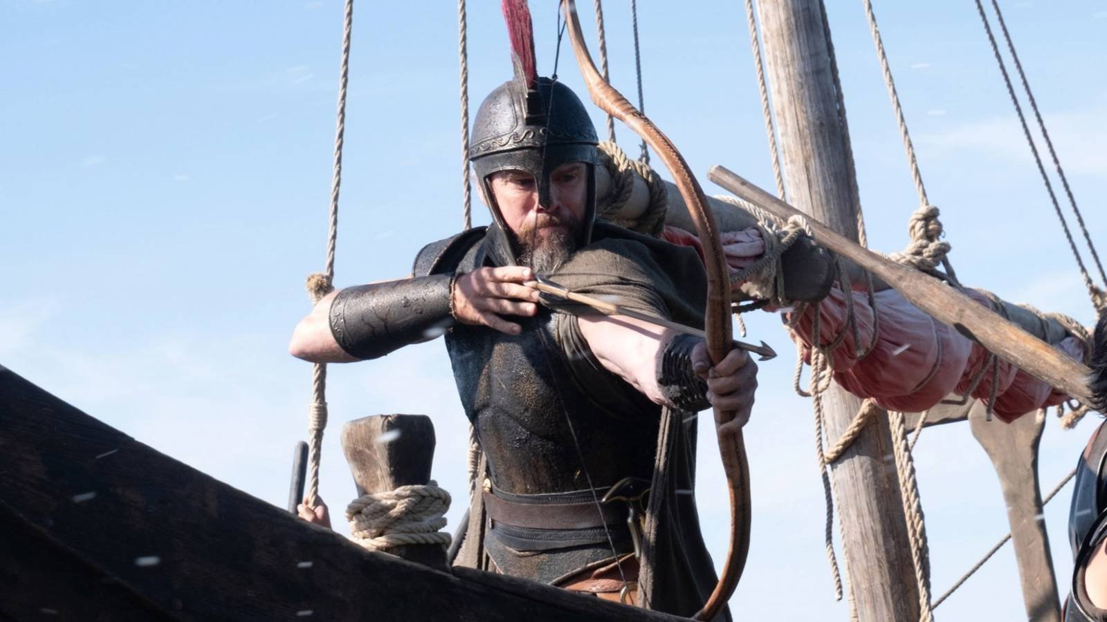 Matt Damon as Odysseus in armor firing a bow and arrow in The Odyssey (2026)
