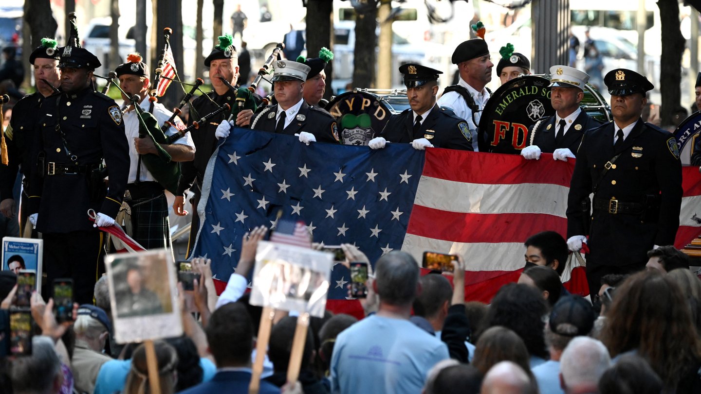 Police and firefighters march at a ceremony commemorating September 11 in 2021. At the 25th anniv...