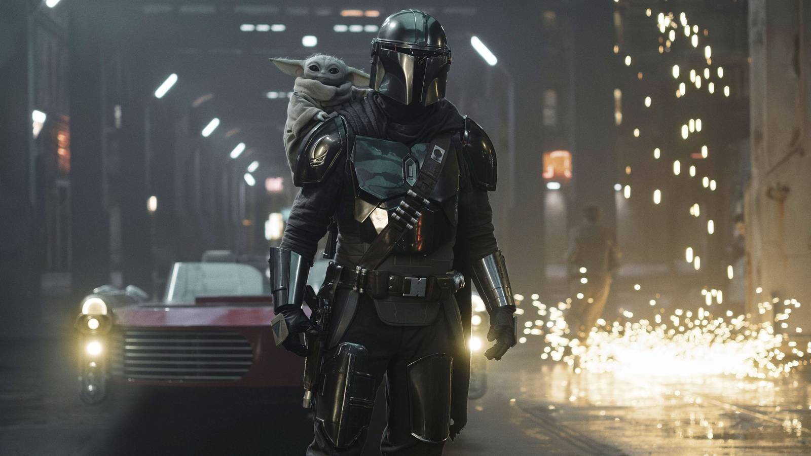 The Mandalorian with Grogu on his shoulder and sparks behind them in The Mandalorian and Grogu
