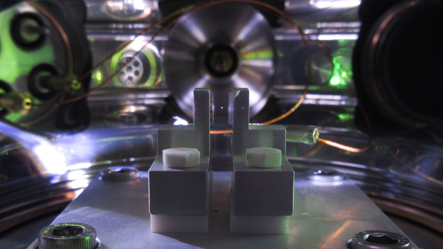 Scientists trapped a nanosphere (the bright spot at center) with a laser inside an experiment tha...