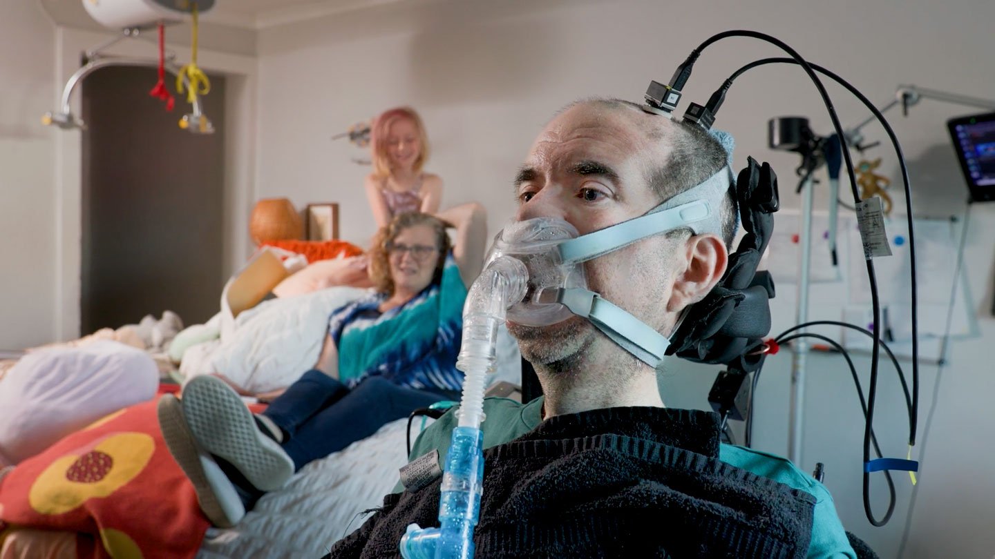 Casey Harrell, here at home in the summer of 2026, uses a brain-computer interface to communicate...